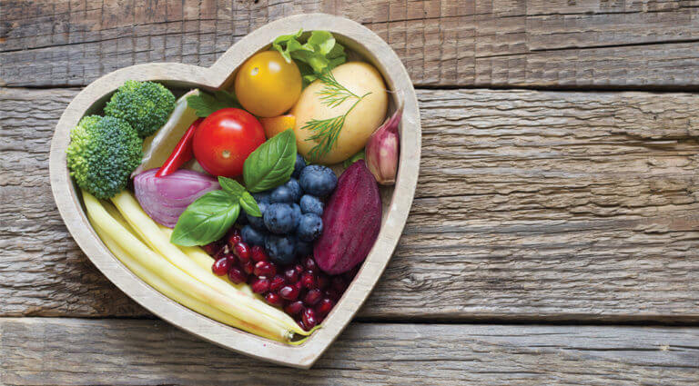 Heart shaped bowl with berries and vegetables