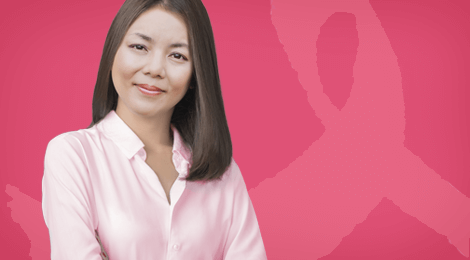 Female smiling with pink ribbon in background