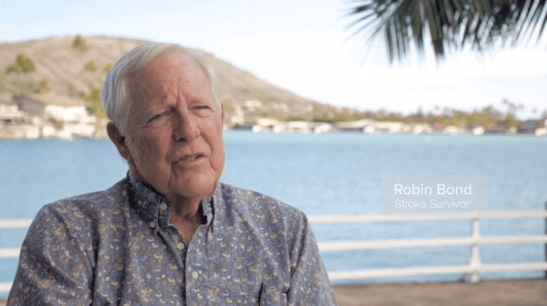 Stroke patient Robin B., Jr. talking with ocean in the background