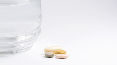 Glass of water with medications