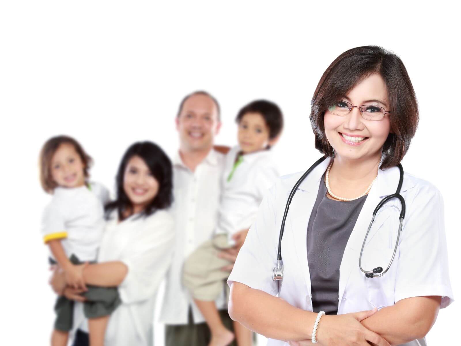 Female doctor smiling with burred out family smiling in the backgorund