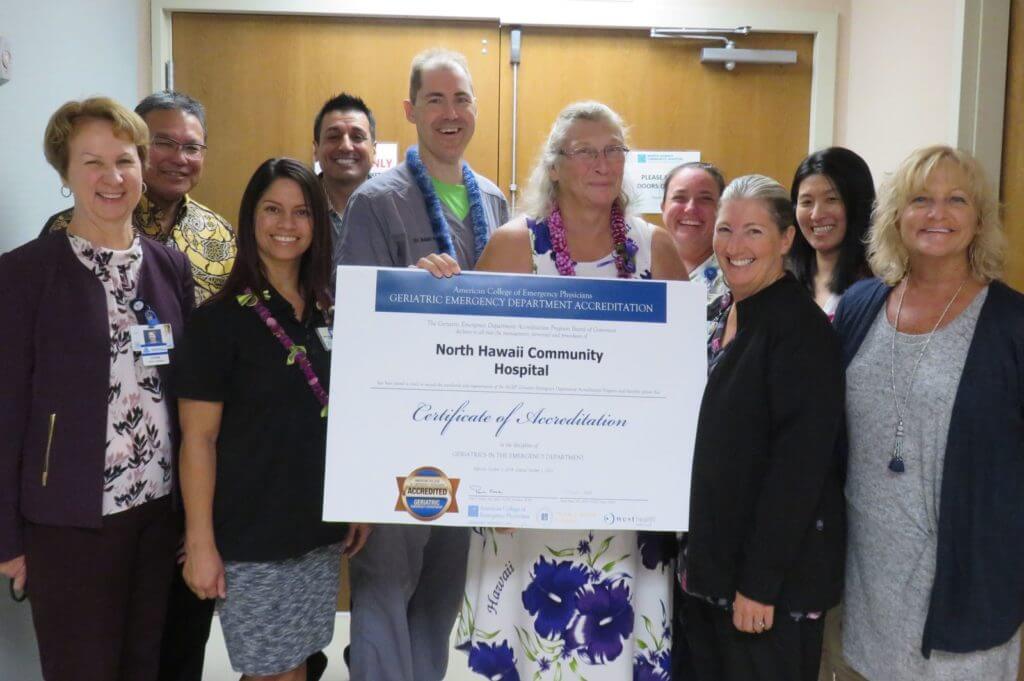 Emergency staff holding up Certificate of Accreditation