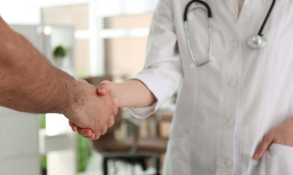 Doctor shaking a patient hand.