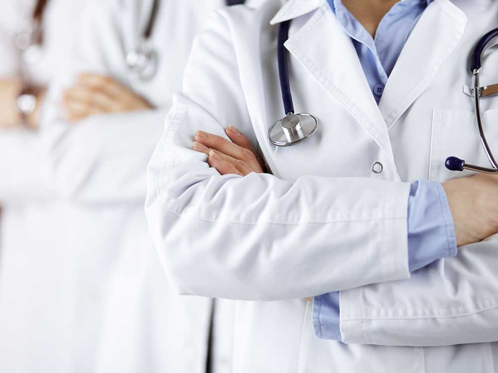 Line of doctors with their arms crossed.