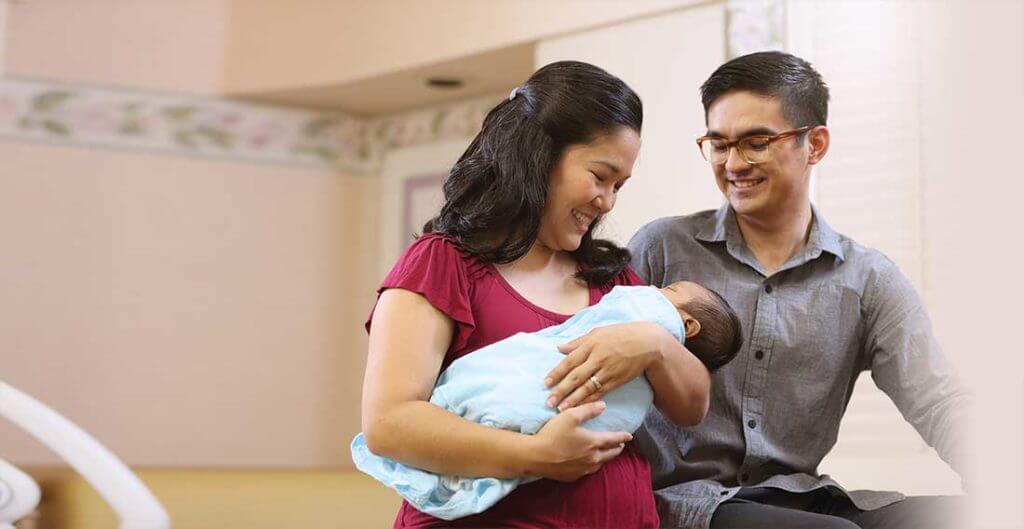 Parents hold their new baby
