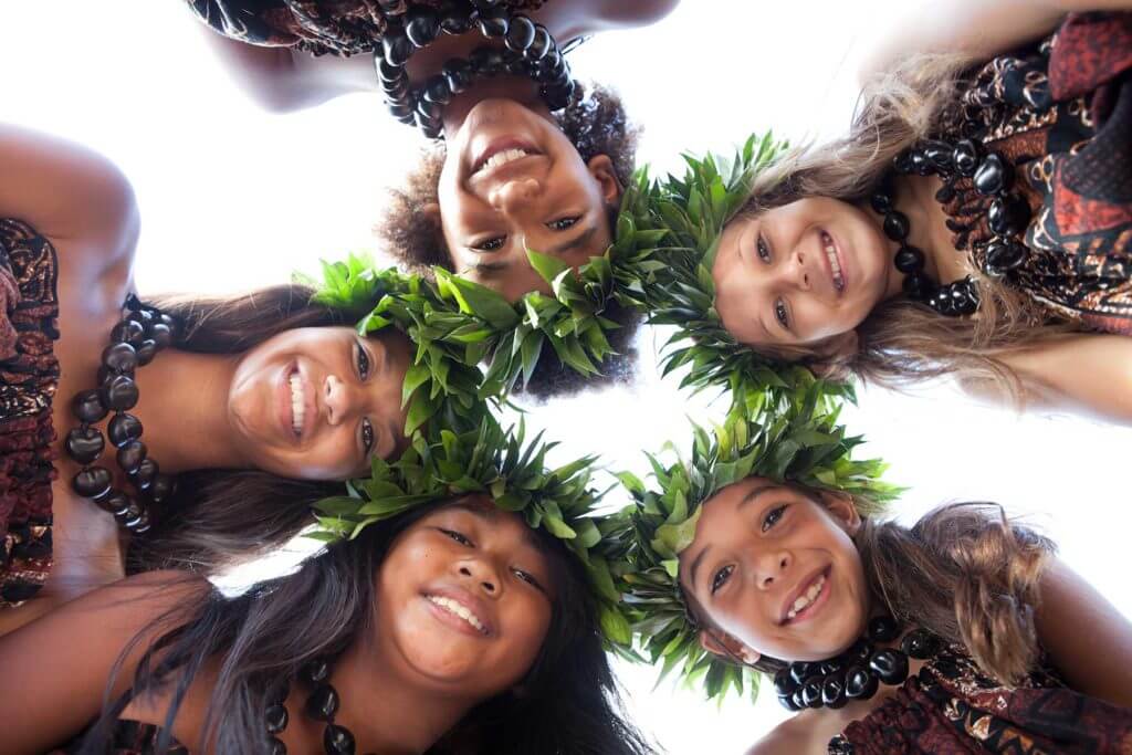 5 girls in circle looking down at camera