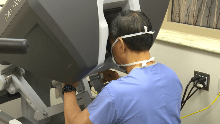 Surgeon practices using a robotic surgery device.