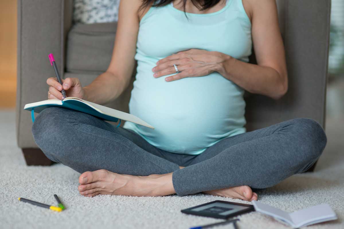 Pregnant woman reading about heart health