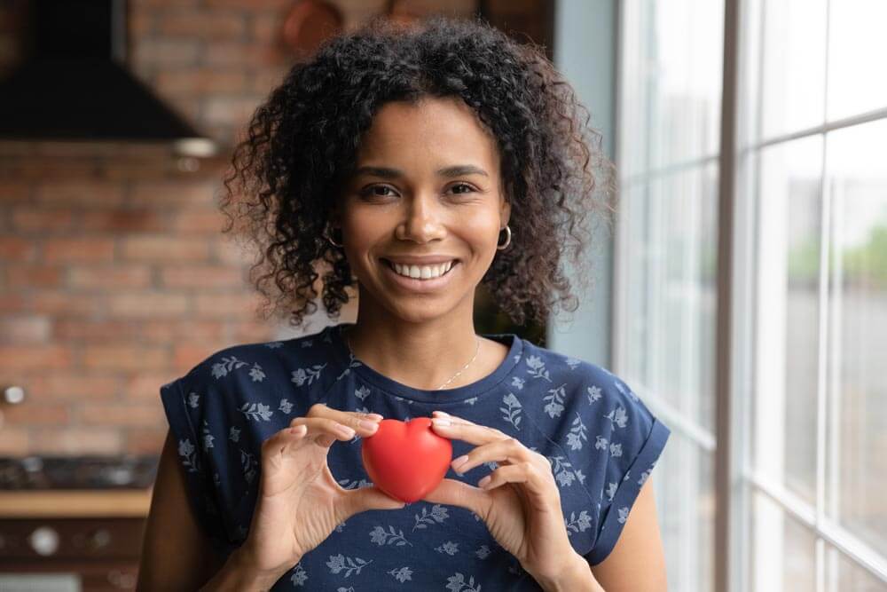 Woman holding a red heart prop